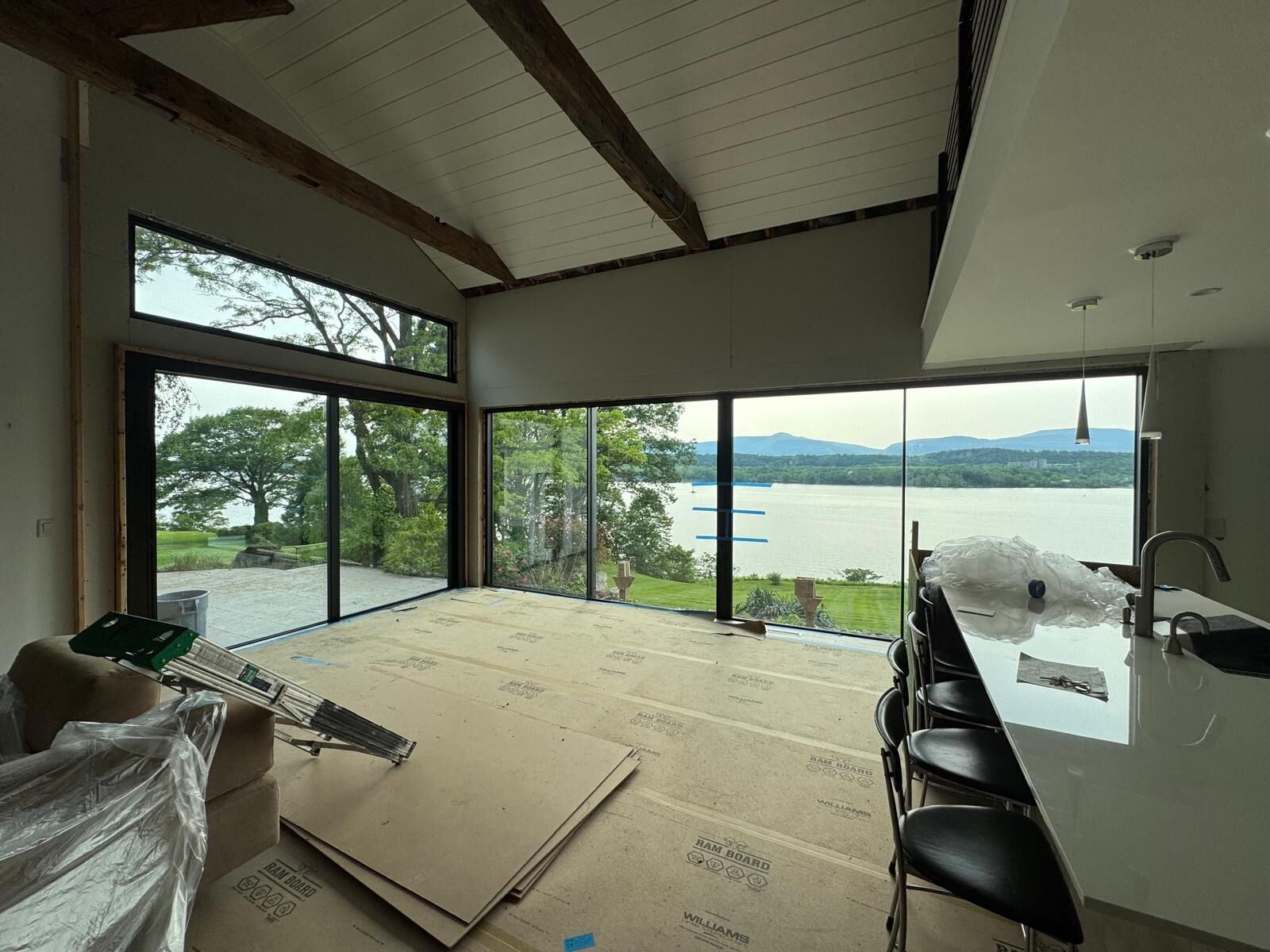 Interior of a great room with a long window wall and lake view