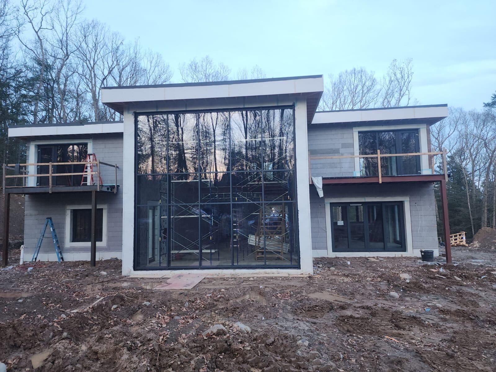 Two-story glass facade on a new waterfront-style home