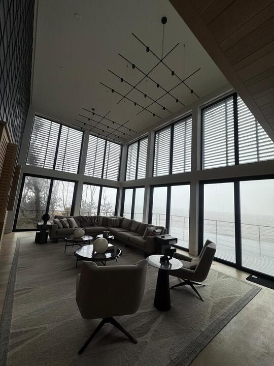 Great room with a tall corner window wall